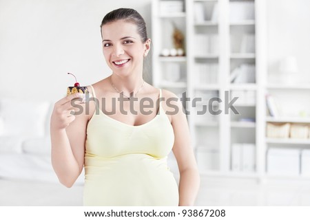 Young pregnant woman with cake