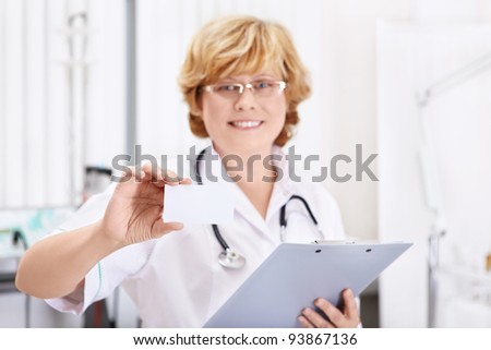 Mature doctor with business card