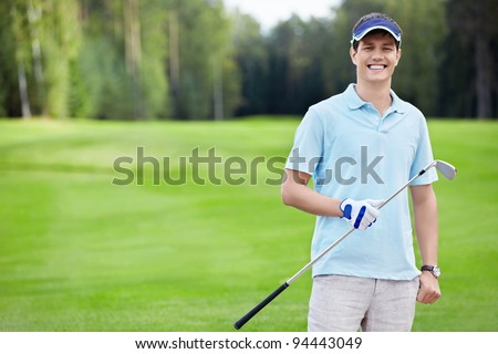 A young man with a stick on the golf course