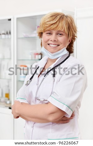Mature doctor with mask indoors