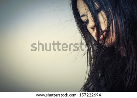 Young girl with dark hair on a white background