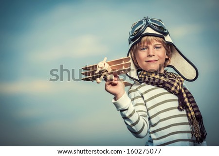 Little Boy With A Plane On Sky Background