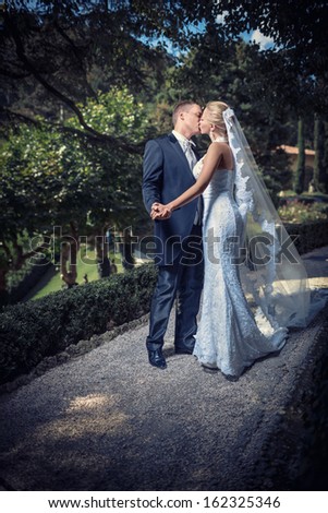 Kissing married couple in park