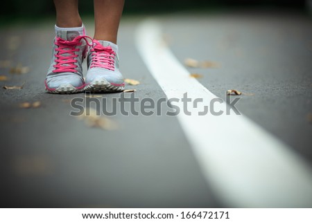 Legs in sneakers on the track Legs in sneakers on the track