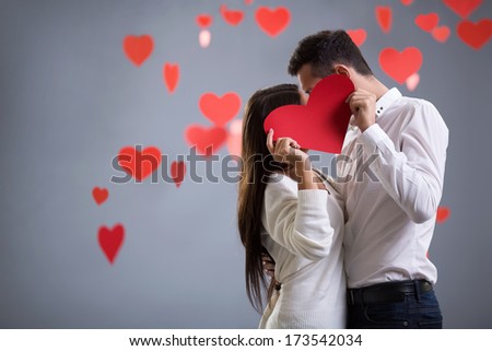 Young kissing couple with heart