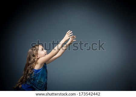 Little girl pulls hands up