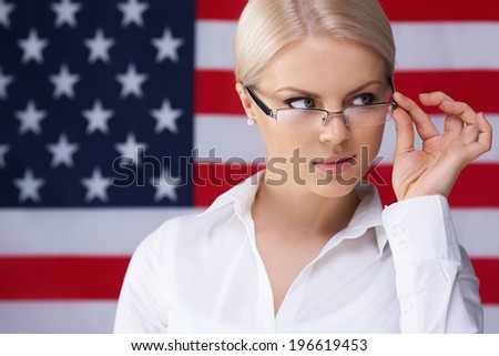 Young girl with her mouth sealed over American flag background