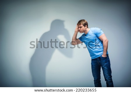 Young man with shadow in studio