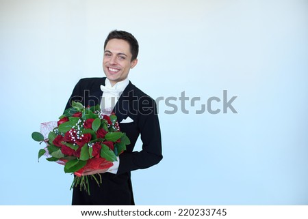 Young man in a tuxedo with a bouquet