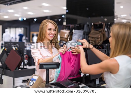 Woman at the checkout makes shopping