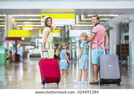 Family with suitcases in the airport