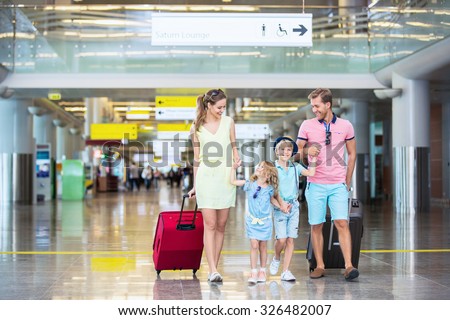 Family with children with a suitcase at the airport