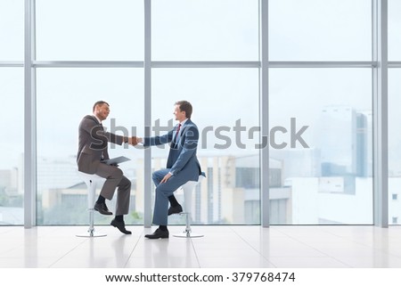 Business partners handshake in office