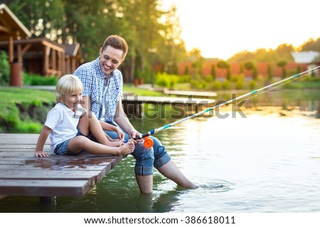 Dad and son fishing in summer