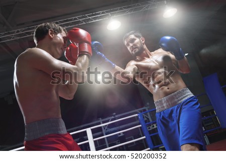 Boxers fighting in a boxing ring
