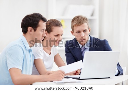 Consultant with a couple looking at laptop