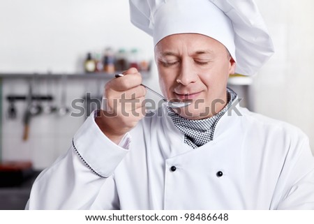 Mature cook prepares in the kitchen