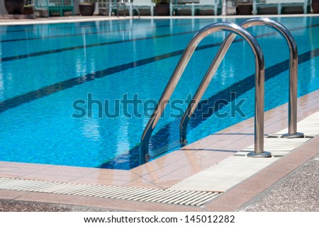 blue swimming pool with stair at sport center.