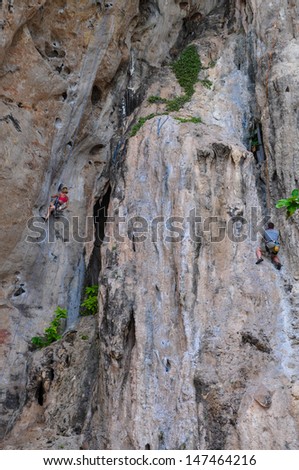 people climbing on the rock route summer (Railay Beach, Krabi province Thailand).