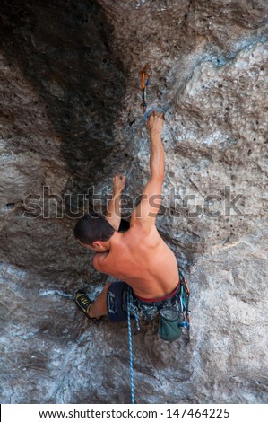 man climbing on the rock route summer (Railay Beach, Krabi province Thailand).