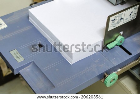 printer tray with paper in the office.