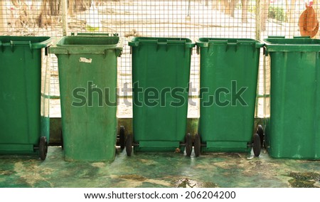 overfilled trash of large bins for rubbish, recycling and garden waste.