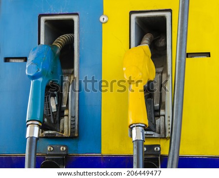 Gas pump nozzles in a service station
