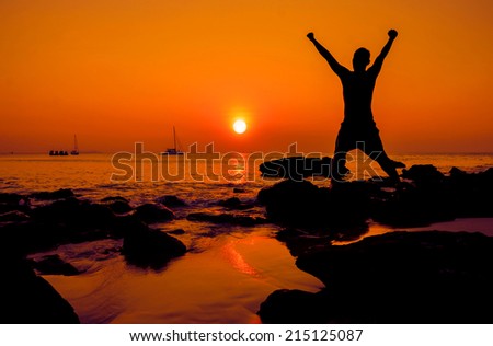Happy jump during sunset at the beach.