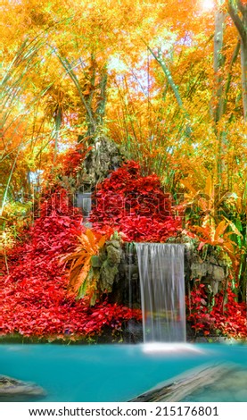 Wonderful Waterfall and red leaf in Deep forest at National Park, Thailand.