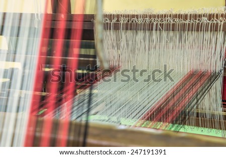 Weaving loom and shuttle on the warp.