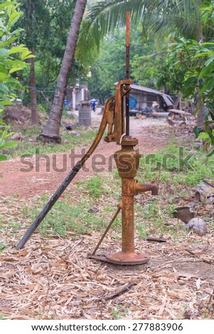Hand water pump retro style in garden.