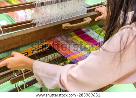 Weaving loom and shuttle on the warp.