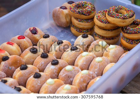 various glazed donuts in box at the market.