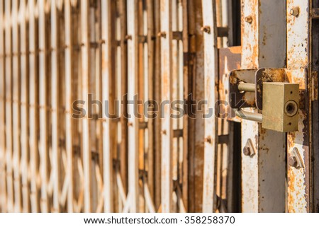 master key on old iron gate background.