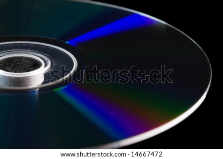 Close-up of a section of a blank Blu-ray disc with blue refraction rays against black background