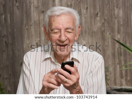Old elder senior man on mobile smart phone
