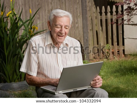Old man senior citizen using laptop computer