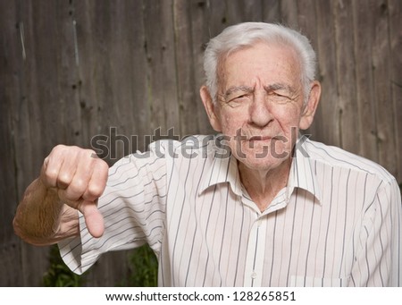 Grumpy old man giving thumbs down