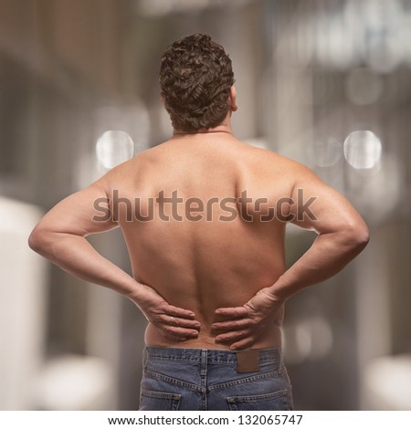 Lower back pain on fit adult man