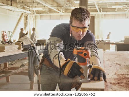 Carpenter At Work At Industrial Job Site