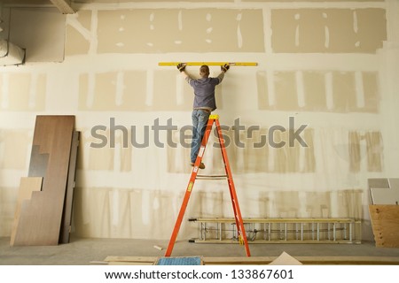 Construction area with man working on ladder