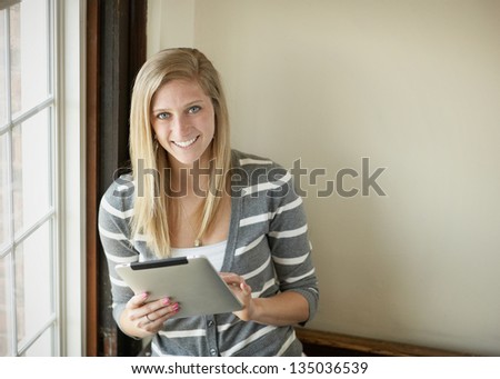 Beautiful young woman college student with tablet computer