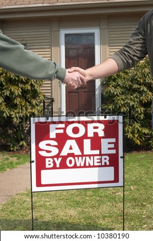 Handshake over home for sale sign