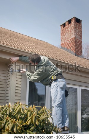 Man working on house ready to hammer a nail