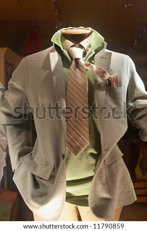 Storefront of upscale man\'s clothing store mannequin