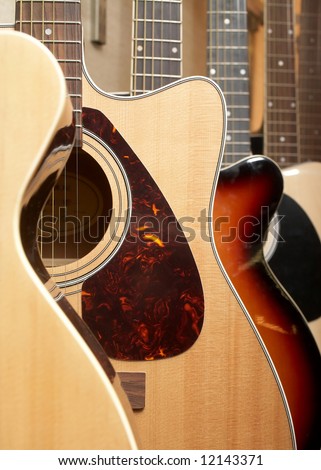 Acoustic guitars hanging on wall of music shop