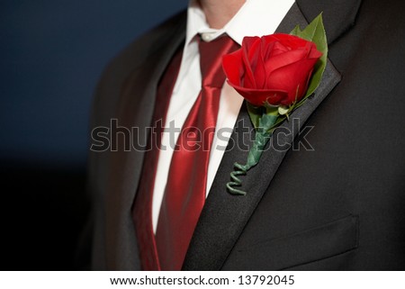 stock photo Wedding Red Rose Boutonniere On Suit Jacket of Groom