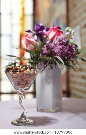 Cocktail glass filled with chocolate cashew nuts at formal party