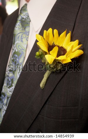 stock photo Sunflower Wedding Boutonniere On Suit Jacket of Groom