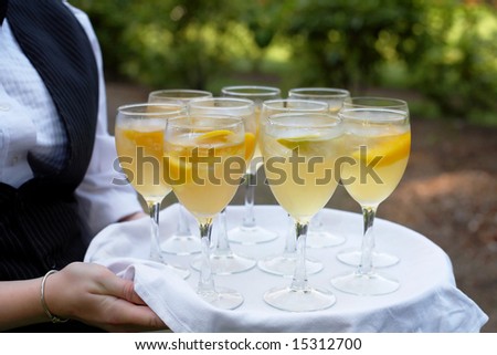 Glasses of mimosa being served at fancy party